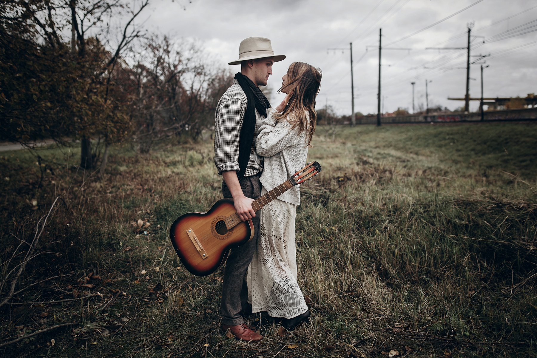 Rustic Wedding Concept. Boho Gypsy Woman and Man with Guitar Pos